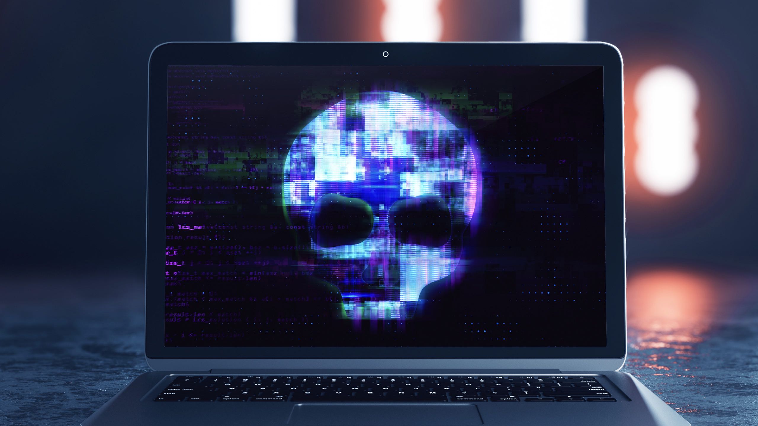 Laptop screen with abstract digital skull on grunge background.