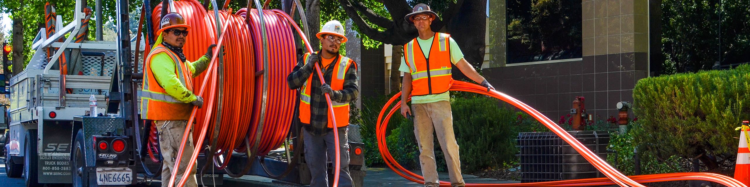Sonic installers on streets laying down fiber-optic internet.