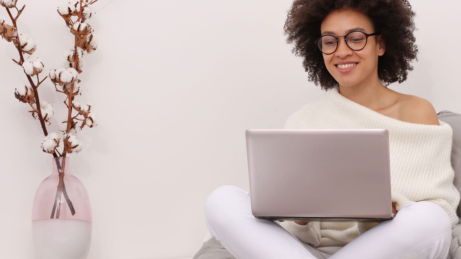 Happy casual woman enrolling in ACP on a laptop.